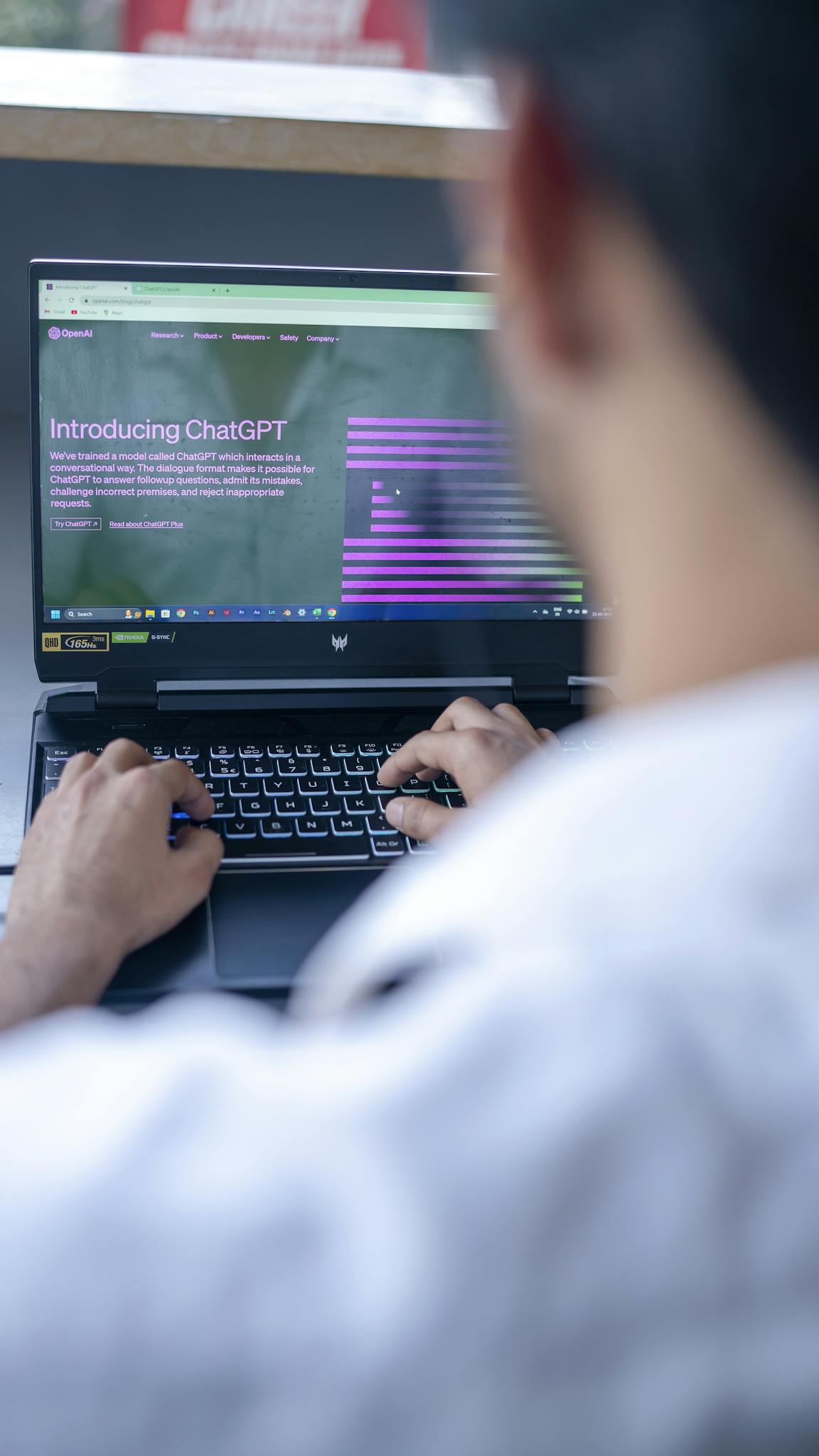 Focused shot of a man using ChatGPT on laptop. Ideal for tech-related content.